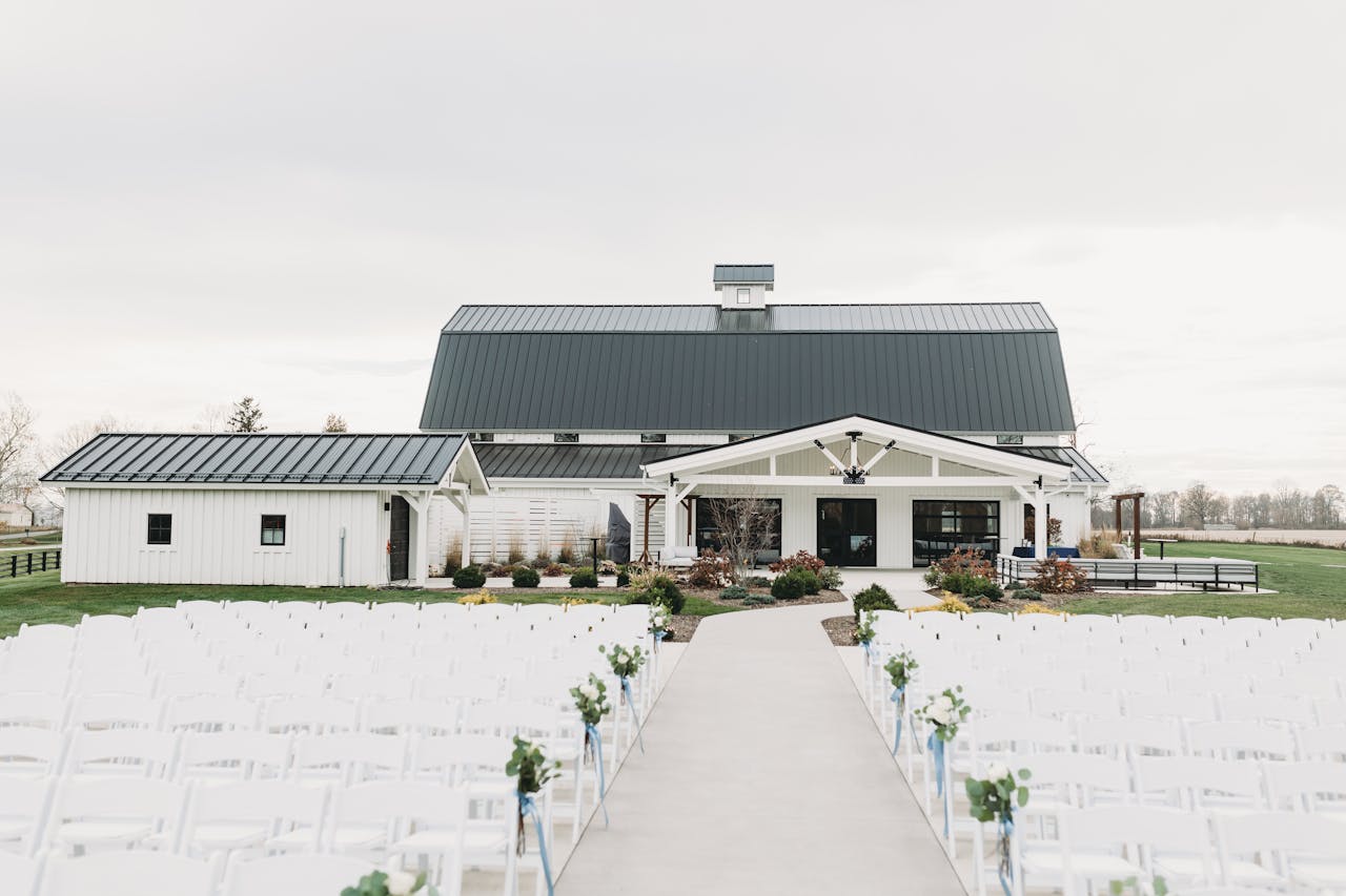 A picturesque barn venue for weddings with outdoor seating, perfect for a rustic ceremony.